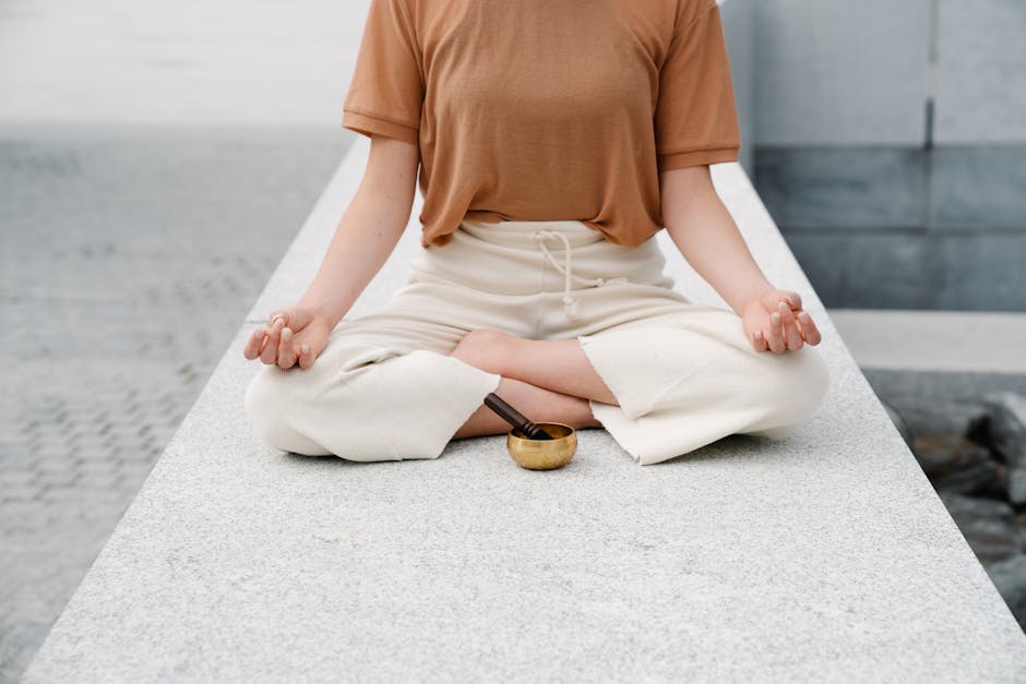 A person meditating outdoors with a singing bowl, embracing serenity and mindfulness.